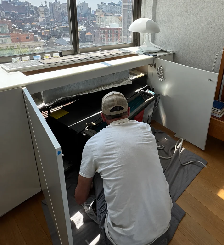 Technician preparing an existing PTAC unit for replacement