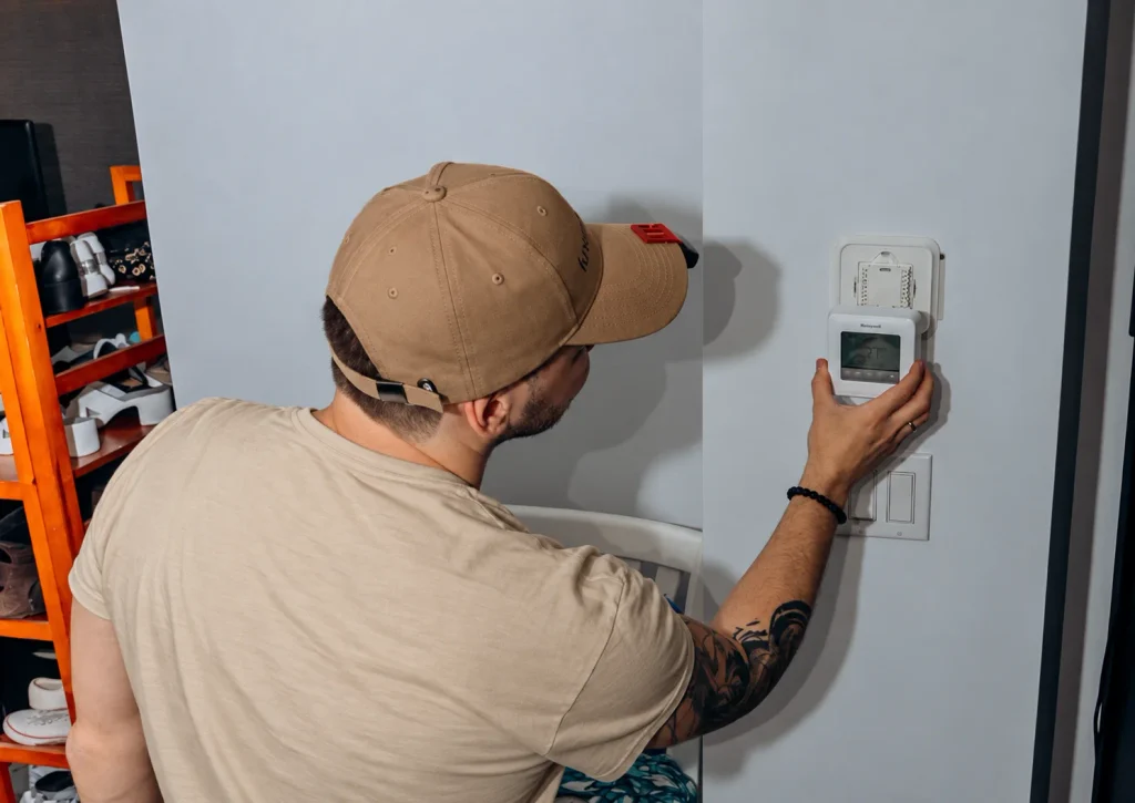 Technician testing a wall thermostat after PTAC service
