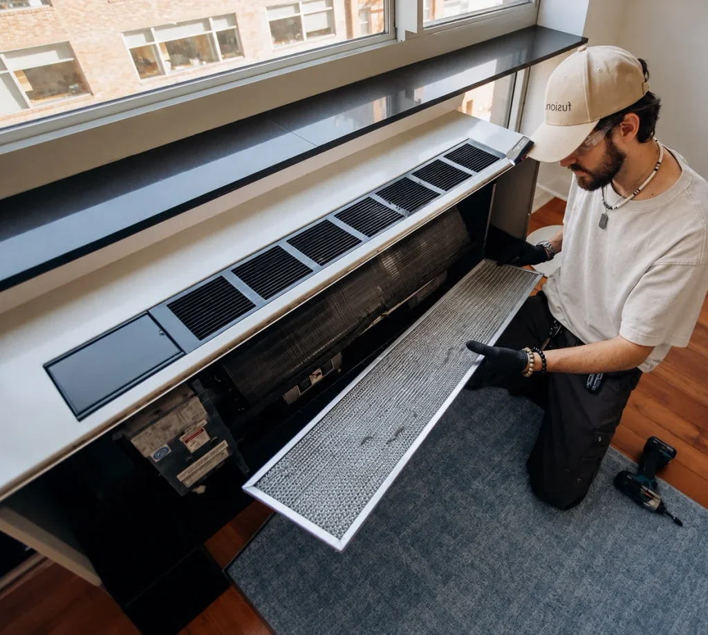 Technician checking a packaged terminal air conditioner before installation